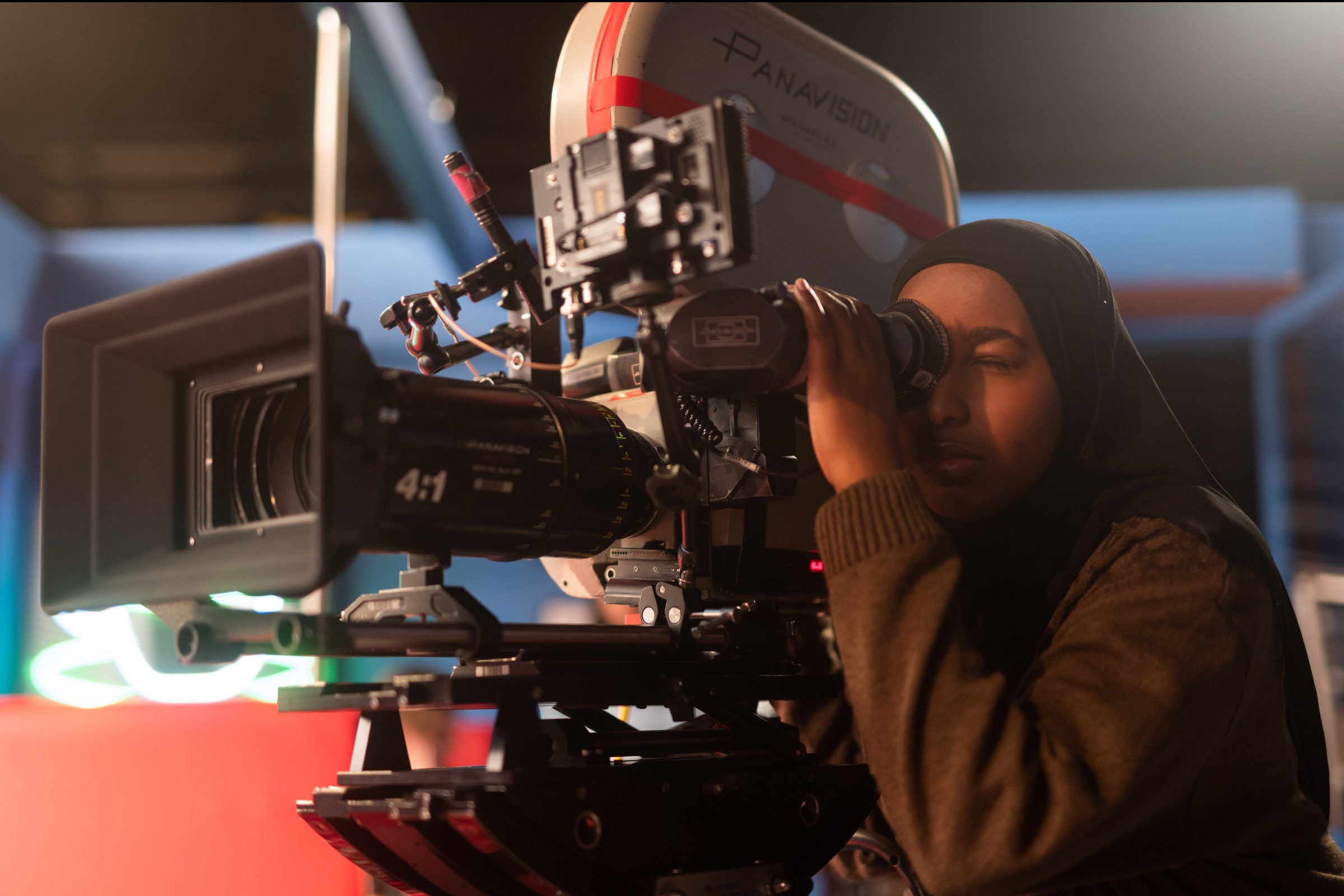 An LSA student looking through the viewfinder of a Panavision cinema camera in the studio